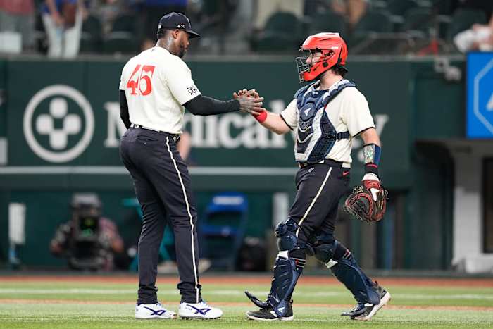 Aroldis Chapman, left, and catcher Austin Hedges celebrate the Texas Rangers' 3-2 win over the Oakland Athletics on Sept. 9 at Globe Life Field.